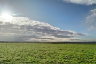 Low sun and cloudy sky over Flat Fields at Blue House Farm