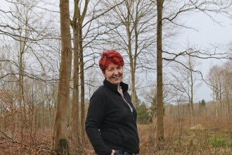 Anne standing in a woodland