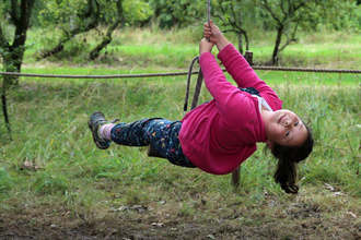 Child swinging on rope