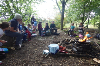 Children sitting around a fire