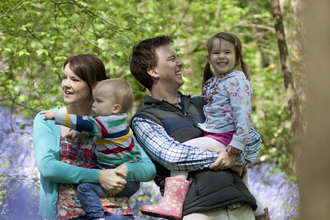 Family in bluebell wood