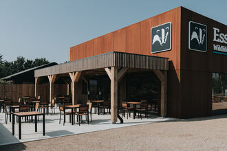 Front of building with chairs and tables. 