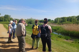Small group of people looking at a lake