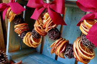 Festive garland with red bows and dried orange.