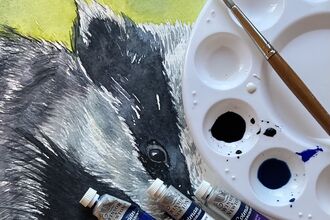 picture of a badger in Watercolour with paints covering some of the picture.