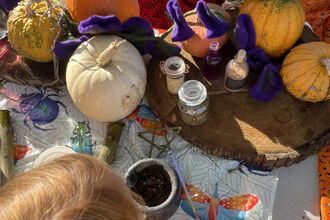 Child making potions and wands at a Halloween event