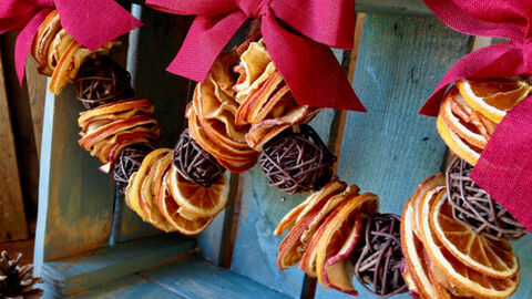 Festive garland with red bows and dried orange.