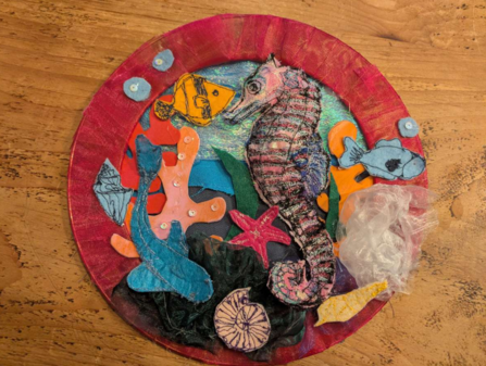 A circular textile collage of sea creatures.