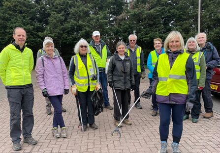 A group of ramblers from Brentwood in high vis with litter pickers 
