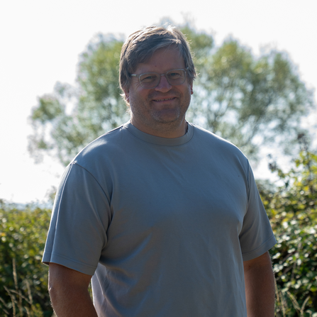 Man in front of tree 