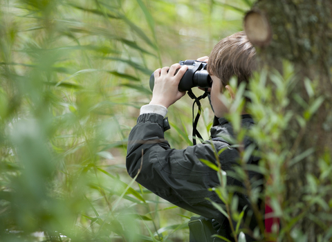 Child outside with binoculars 