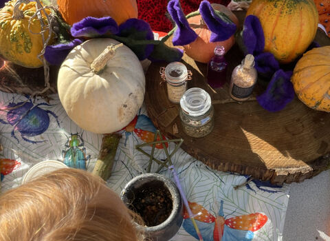 Child making potions and wands at a Halloween event
